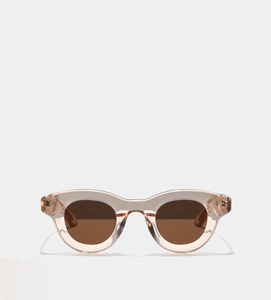 Transparent rose-tinted cat-eye sunglasses with brown lenses.