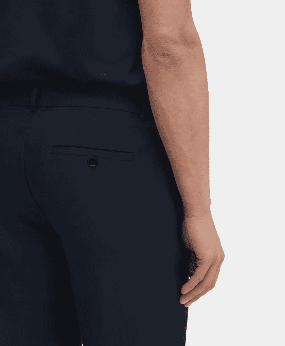 Detail shot of the waistband and fabric of ASKET navy linen trousers