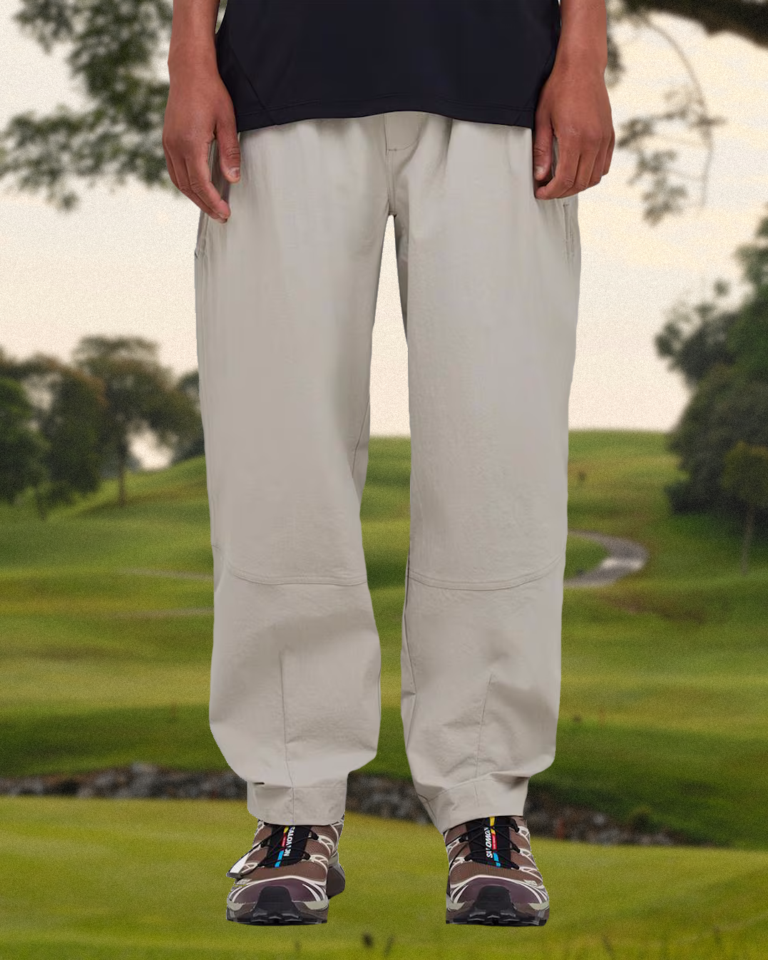 Close-up of Asics technical sneakers paired with golf trousers.