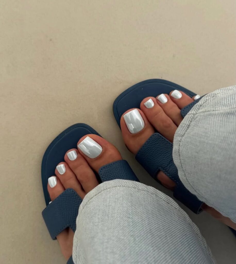 Soft pearl chrome toe nails with a milky iridescent sheen.