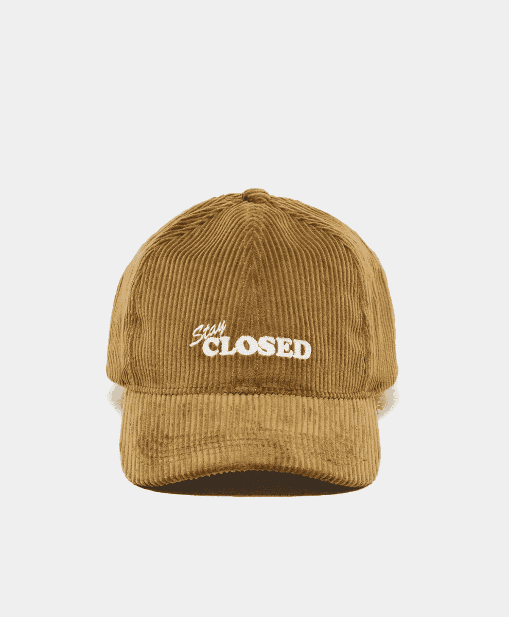 Tan corduroy baseball cap with 'Stay CLOSED' white embroidery on the front.