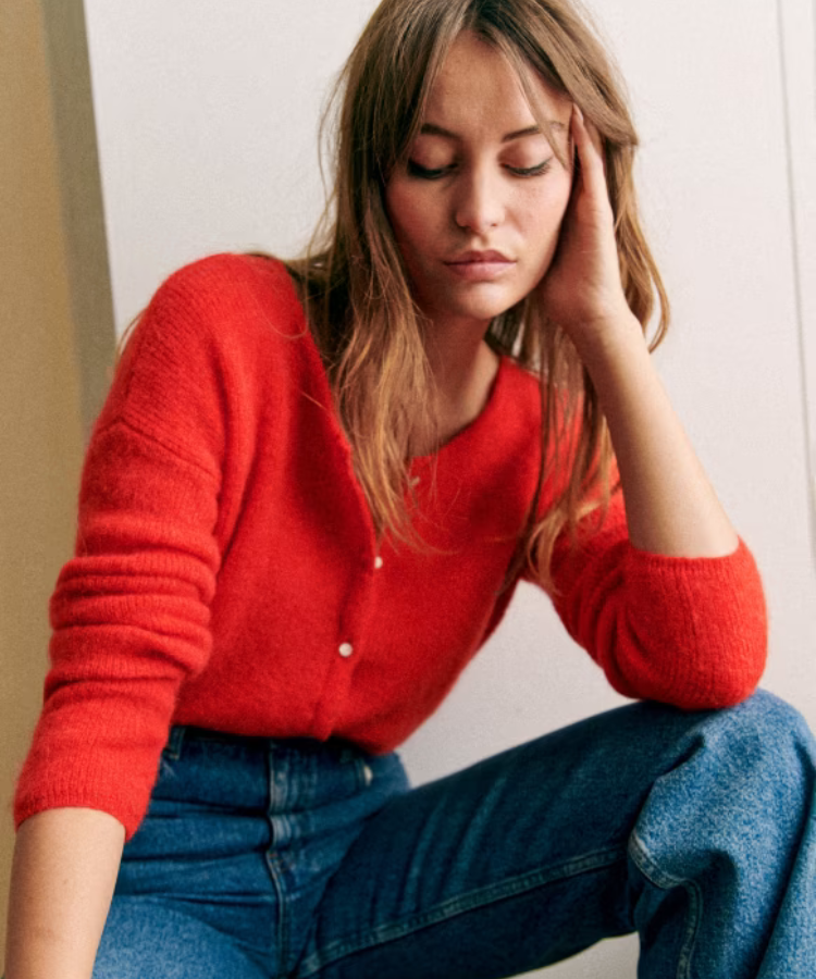 The Sézane Gaspard Cardigan in a bright red shade.